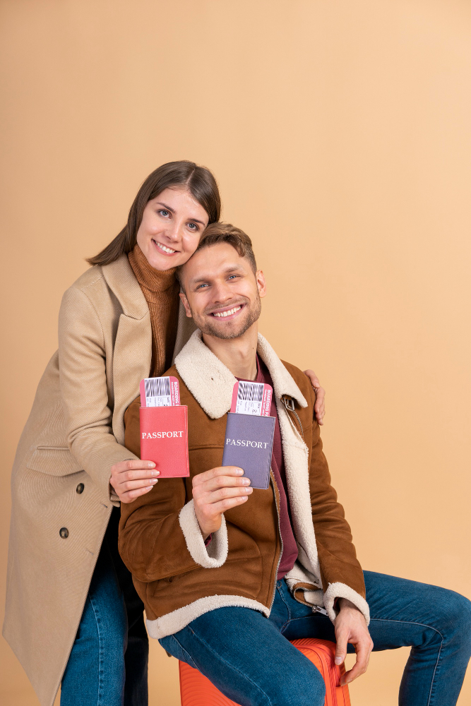 young-couple-posing-together-with-passport-plane-tickets